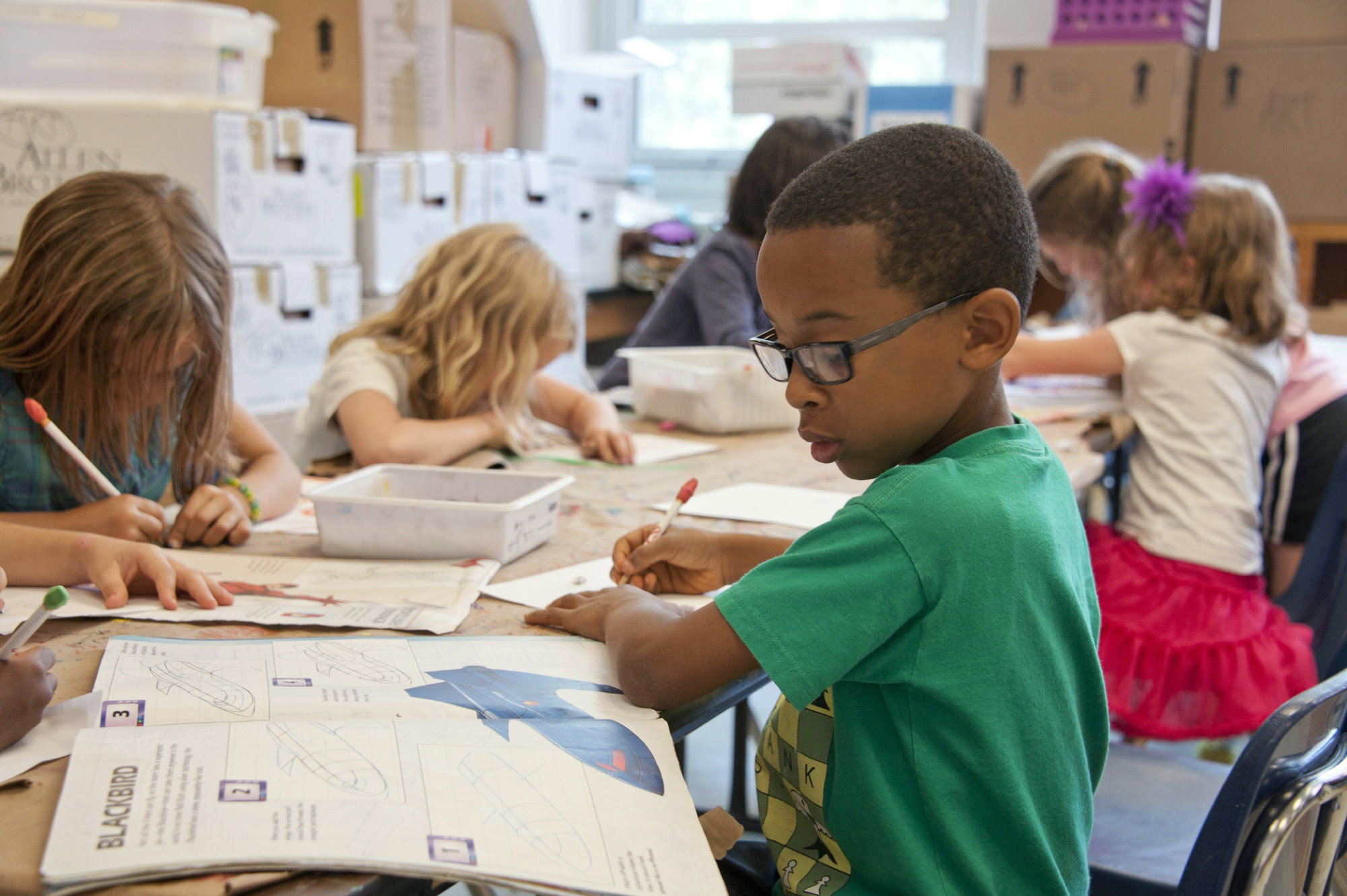 boy-in-green-sweater-writing-on-white-paper.jpg boy in green sweater writing on white paper